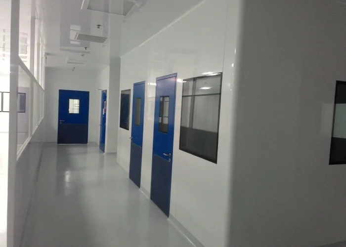 GMP pharmaceutical cleanroom corridor with blue cleanroom doors and pressure zoning layout
