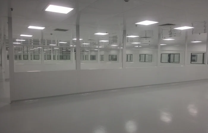 Windowed pharmaceutical cleanroom wall panels with flush joints and cleanable surfaces