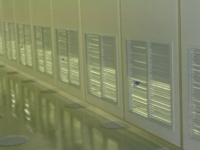 Wonclean real project photo of cleanroom partition walls with multiple low-level return air grilles along a clean corridor