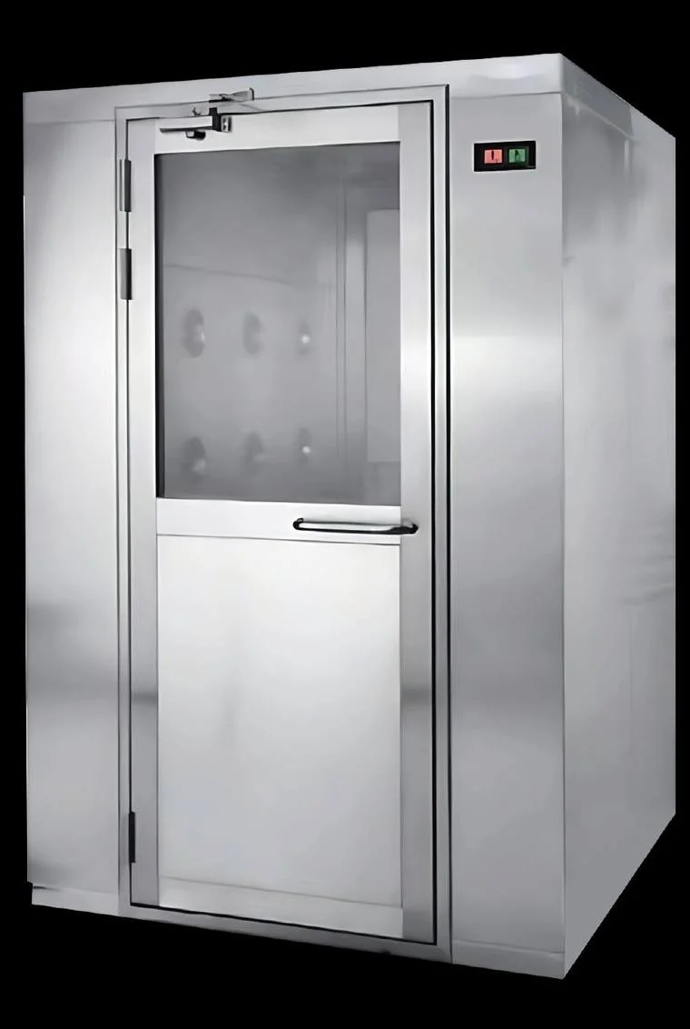 Stainless-steel cleanroom air shower with interlocked doors and multiple jet nozzles, used to remove particles from personnel before entering a clean zone